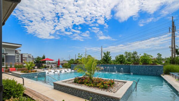 Summit Square pool area with lush landscaping and cloudy skies.