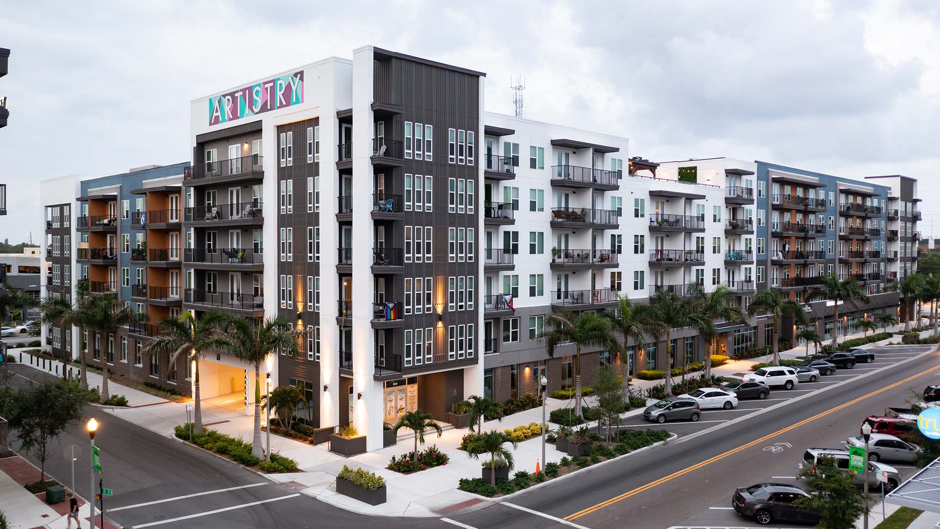 Artistry apartments with modern construction and street parking.
