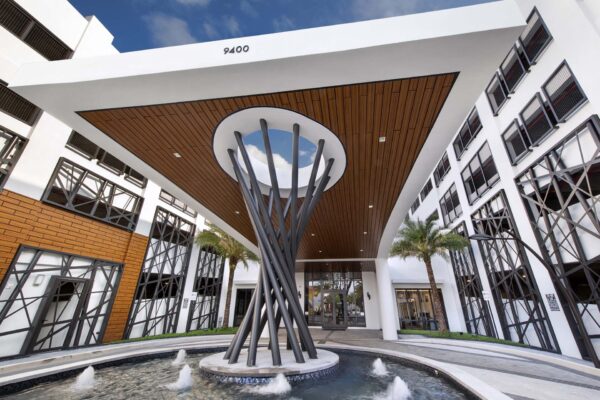 Sanctuary Doral entrance with fountain and large sculptural decoration.