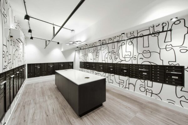 Mail room with mailboxes and line art mural.