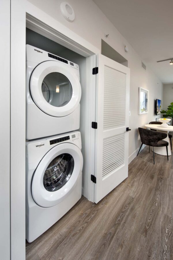 Laundry closet with stacked washer dryer.
