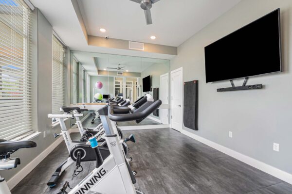 Spin room with bikes and wall mounted TV.