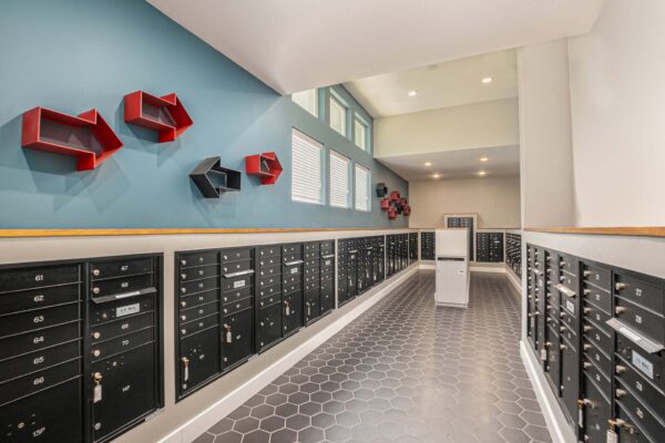 Mail room with mailboxes, parcel lockers, and decor.