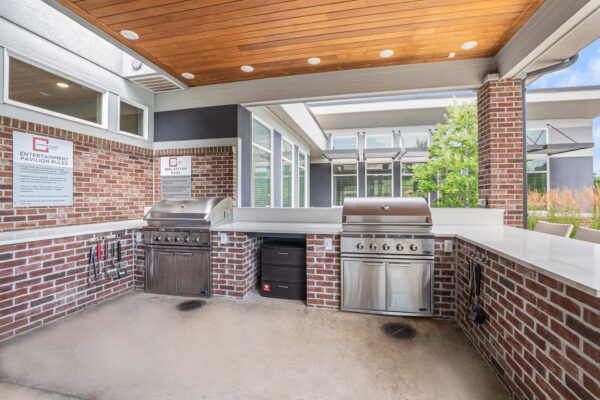 Outdoor barbeque area with built in grills and utensils.