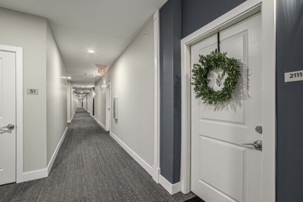 Carpeted hallway and apartment doors at Summit Square apartments.