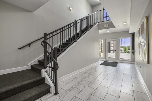 Lobby entrance with tiled floor and staircase.
