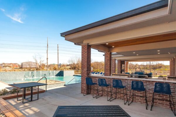 Pool area with outdoor barbeque lounge.