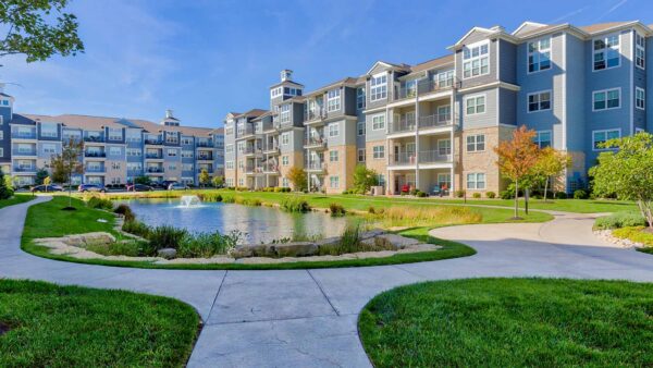 Village West apartments courtyard with lush landscaping and water feature.