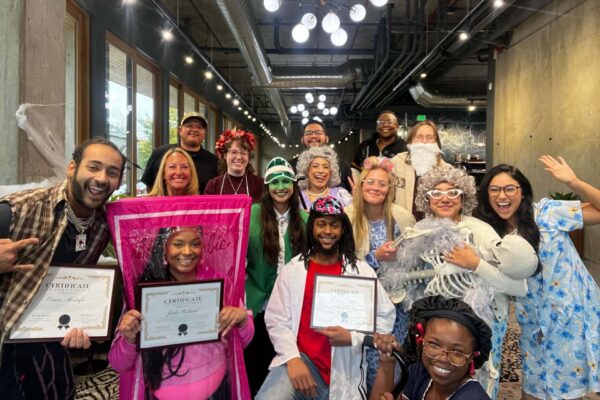 Avanti employees smiling and posing together in costumes.