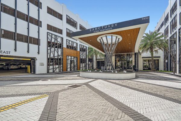 Sanctuary Doral apartments driveway with stone pavers and large sculptural architecture.