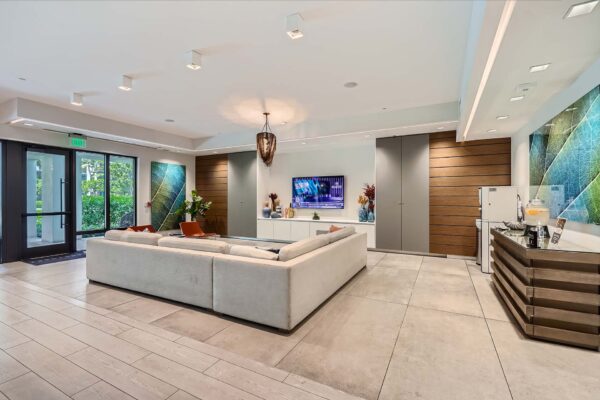 Sanctuary Doral apartments lounge with coffee bar, plush seating, and TV.