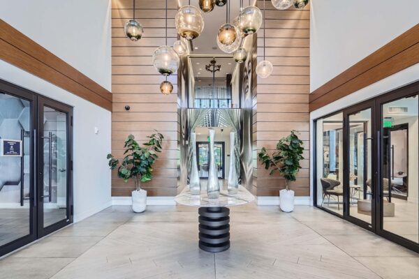 Sanctuary Doral apartments entrance with elegant decor and large light fixture.