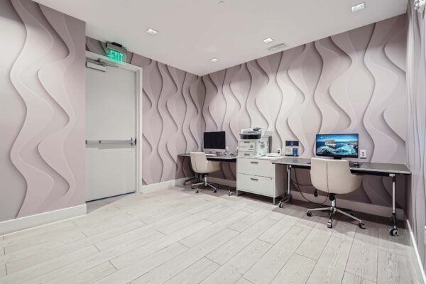 Sanctuary Doral apartments business center with computer desks and printer.