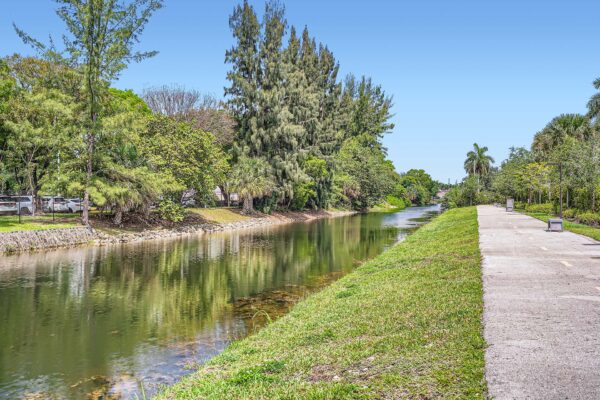 Sanctuary Doral apartments with nearby canal waterway and walking path.