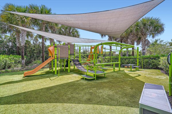 Sanctuary Doral apartments playground with equipment and large shade sails.