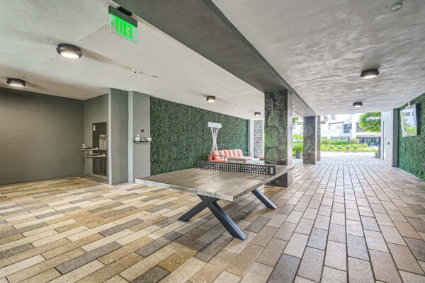 Sanctuary Doral apartments outdoor lounge with table tennis and plush seating.