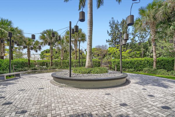 Sanctuary Doral apartments courtyard with stone paver walkways and lush planters.