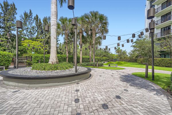 Sanctuary Doral apartments courtyard with stone paver walkways and lush planters.