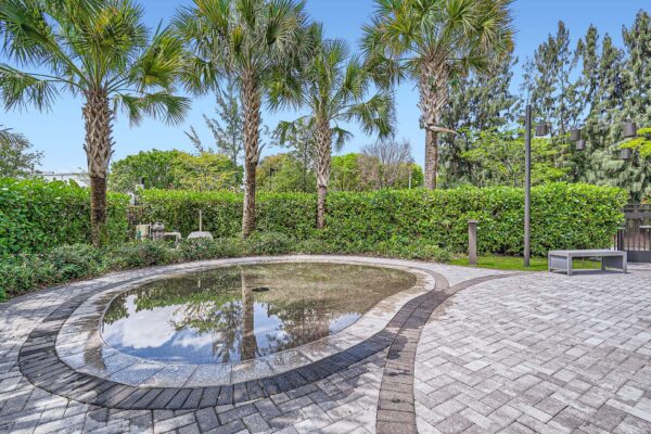 Sanctuary Doral apartments courtyard with stone paver walkways and lush landscaping.