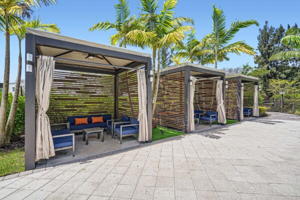 Sanctuary Doral apartments pool area with gazebos and plush seating.