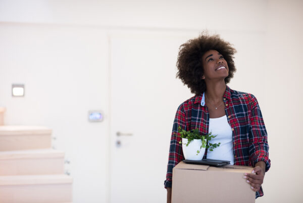 Beautiful African American girl moving in the new apartment
