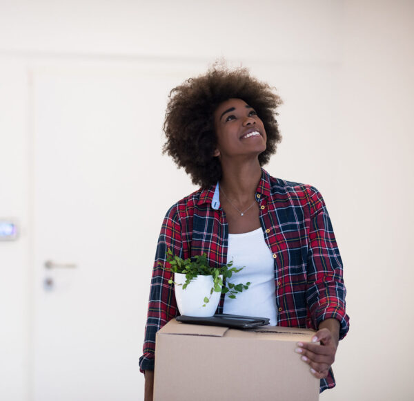 Beautiful African American girl moving in the new apartment