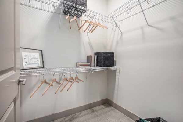 Arte KC apartment closet with built in wire shelving and plush carpet.