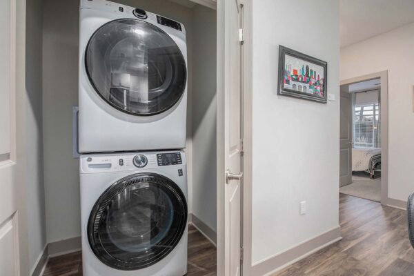 Arte KC apartment laundry closet with stacked washer and dryer.