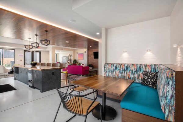 Arte KC lounge with colorfully upholstered booths and elegant lighting.