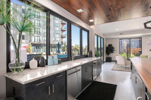 Arte KC community kitchen with stainless steel appliances, elegant countertops, and large windows.