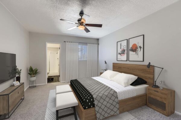 Aura at Midtown apartment bedroom with wood bed frame, ceiling fan, and large windows.