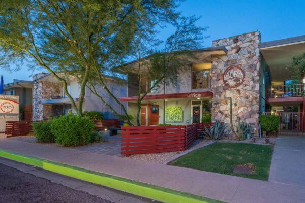 Aura at Midtown apartments with classic mid century stone construction and lush landscaping.