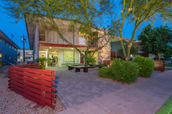Aura at Midtown apartments with classic mid century stone construction and lush landscaping.