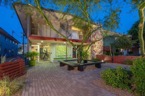 Aura at Midtown apartments with classic mid century stone construction and lush landscaping.