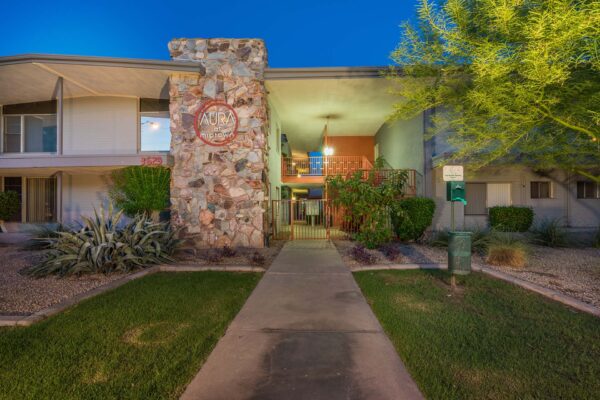 Aura at Midtown apartments with classic mid century stone construction and lush landscaping.