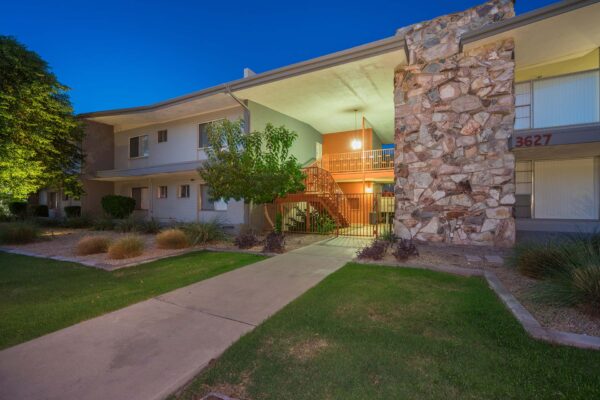 Aura at Midtown apartments with classic mid century stone construction and lush landscaping.