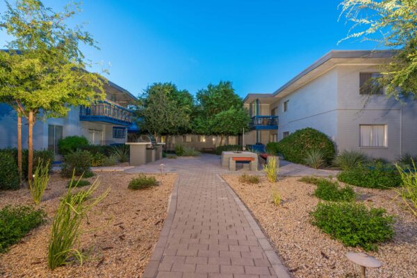 Aura at Midtown apartments with classic mid century architecture and lush landscaping.