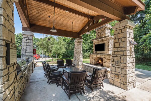 Highlands Lodge apartments outdoor gazebo with plush lounge chairs, fireplace, and TV.