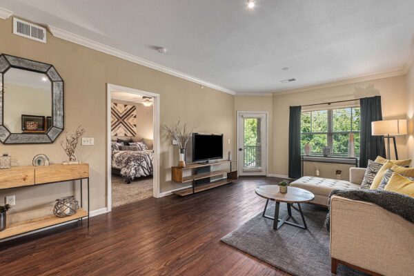 Highlands Lodge with wood style floor, plush seating, elegant decor, and balcony door.