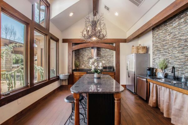 Highlands Lodge apartments community kitchen with wood style floor and cabinets and stainless steel appliances.
