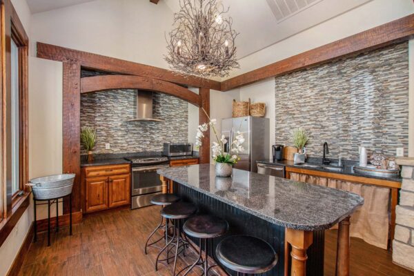 Highlands Lodge apartments community kitchen with wood style floor and cabinets and stainless steel appliances.