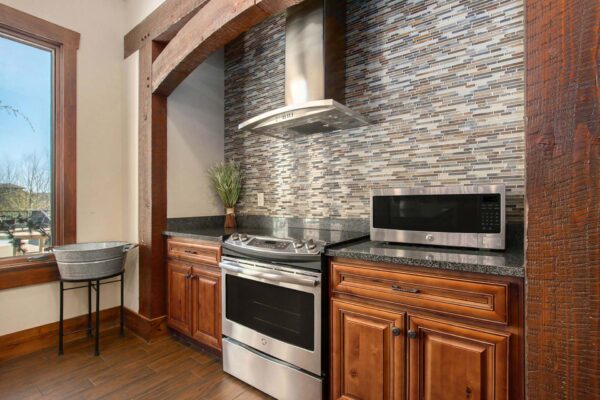 Highlands Lodge apartments community kitchen with wood style floor and cabinets and stainless steel appliances.