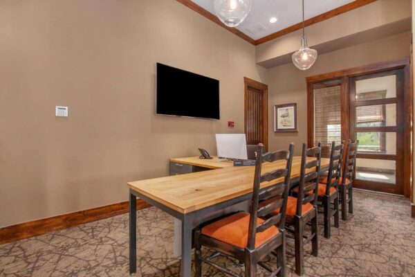Highlands Lodge apartments leasing office with pattern carpets, plush chairs, and large desks.