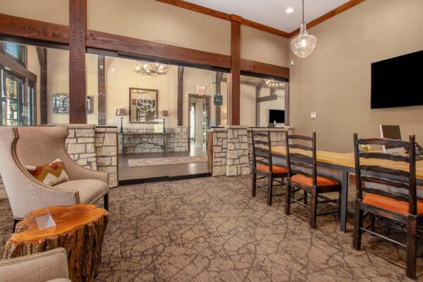 Highlands Lodge apartments leasing office with pattern carpets, plush chairs, and large desks.