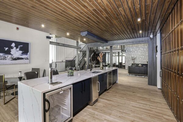 Kenilworth apartments clubroom with elegant bar, wine storage, and dining table.