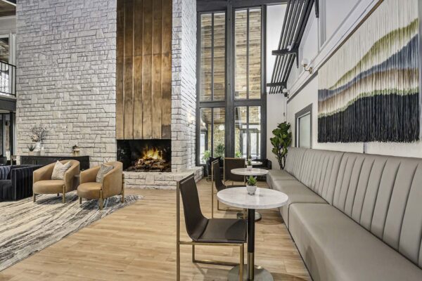 Kenilworth clubhouse with plush seating, metal and stone fireplace, and vaulted ceilings.