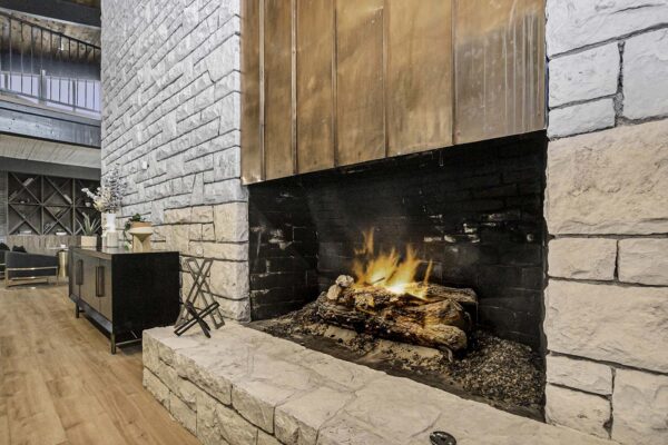 Kenilworth apartments clubhouse fireplace with stone and metal construction.