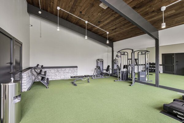 Kenilworth apartments fitness center with weight machines and vaulted ceilings.