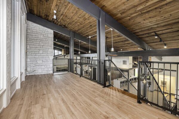 Kenilworth apartments clubhouse mezzanine with wood style floor and metal railings.