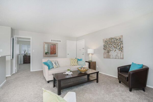 Kenilworth apartment living room with carpet, plush seating, and bright decor.